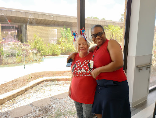 Two women enjoying a moment together in a bright indoor space.
