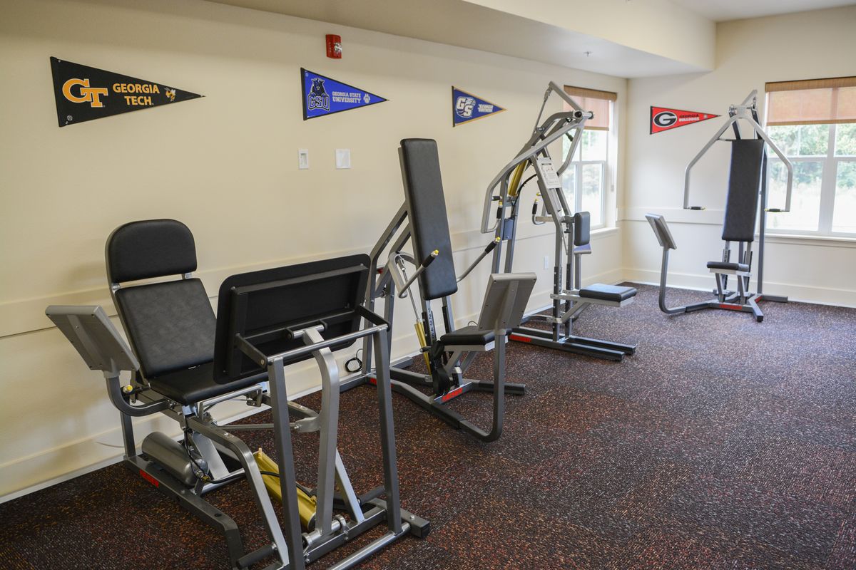 A small fitness room featuring various exercise machines.
