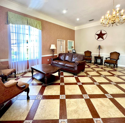 A spacious and elegantly designed living room with a cozy seating arrangement and stylish decor.