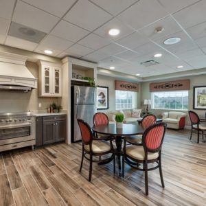 A modern kitchen and dining area with wood flooring and stylish furnishings.