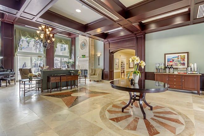 A luxurious hotel lobby featuring elegant decor and a grand chandelier.
