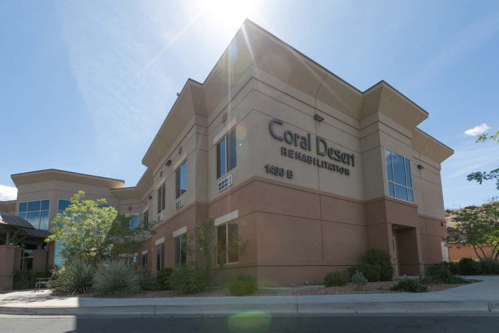A commercial building with sunlight shining above, featuring the name 'Coral Desert Health Center'.