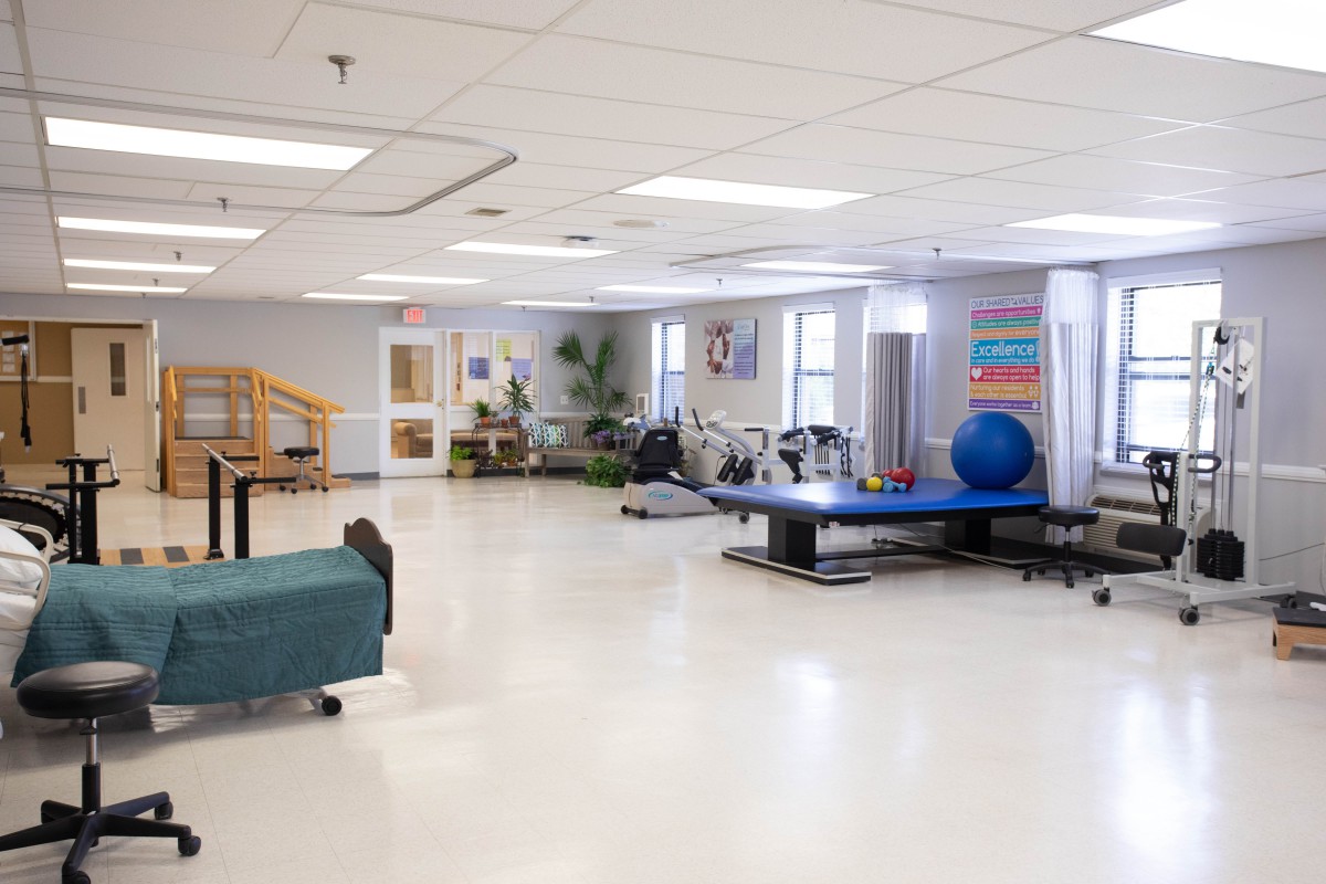 A spacious rehabilitation center equipped with various physical therapy equipment.