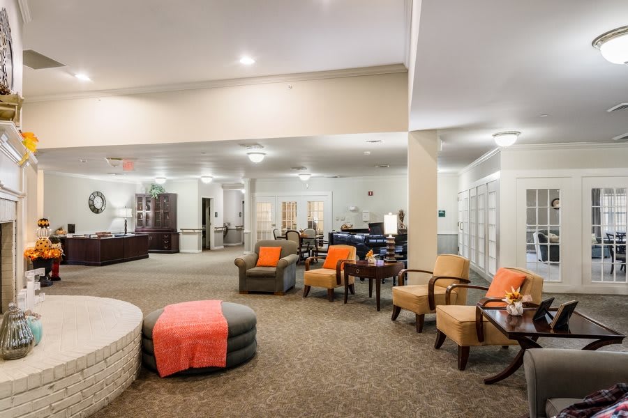 A spacious and cozy lounge area with comfortable seating options, warm lighting, and stylish decor.