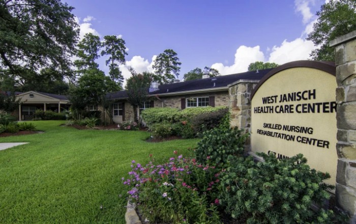 A healthcare clinic with a well-maintained garden and clear signage.