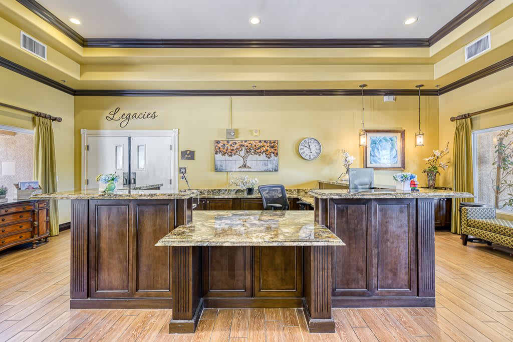 A well-appointed hotel reception area featuring a wood reception desk and elegant decor.