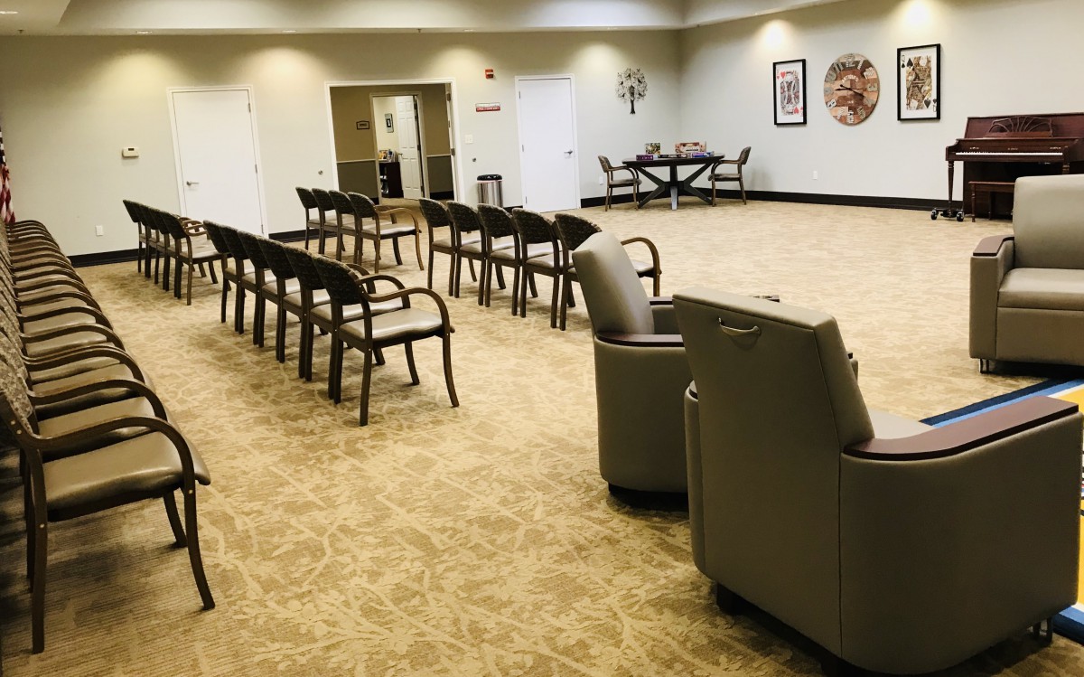 An empty waiting room with rows of chairs and a calm atmosphere.