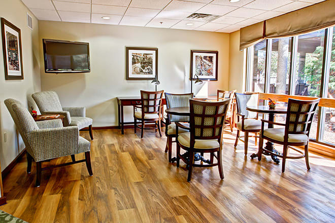 A cozy waiting room with comfortable seating and wooden flooring.