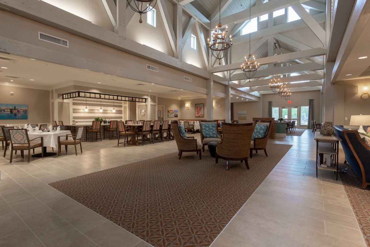 Spacious lobby with elegant chandeliers and comfortable seating.