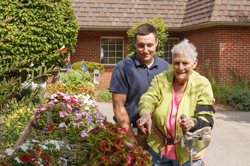 A joyful moment in the garden, showcasing the bond between generations as they tend to beautiful flowers.