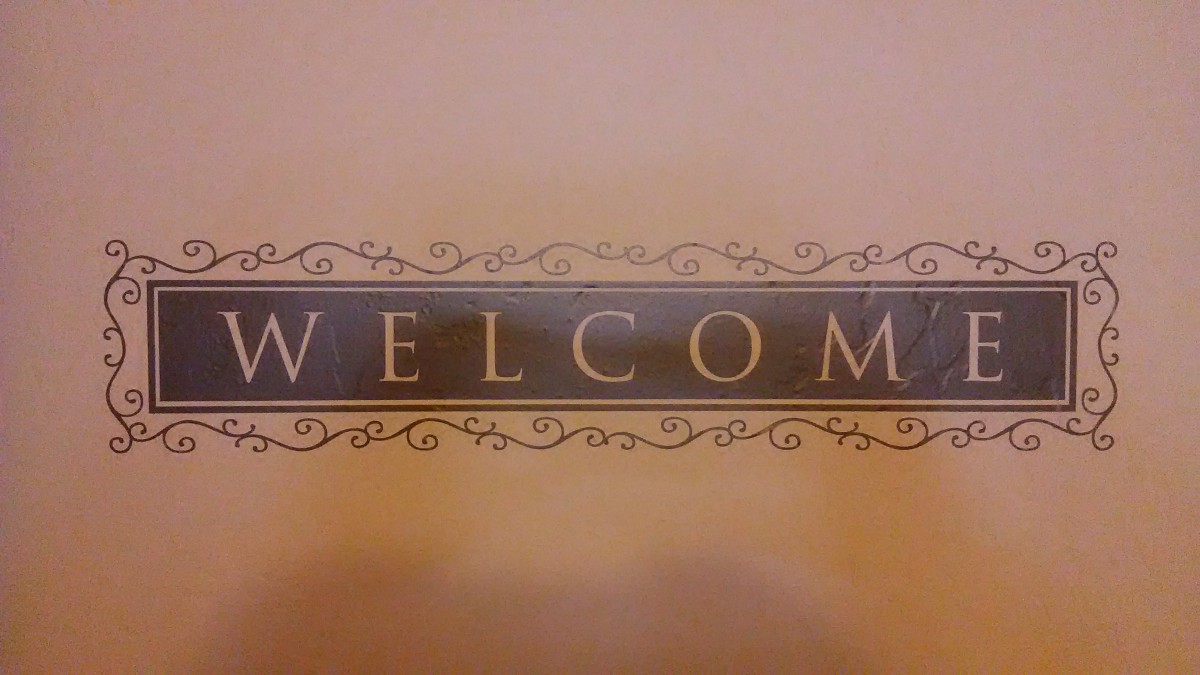 A decorative welcome sign with ornate design.