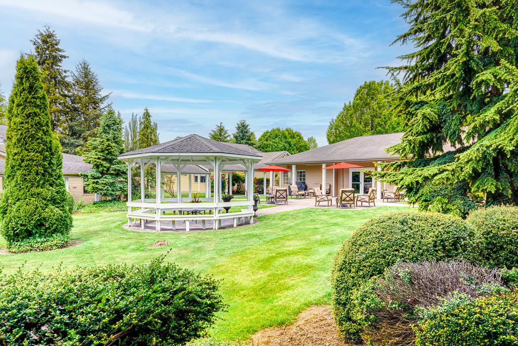 A beautifully landscaped backyard featuring a gazebo and patio area.