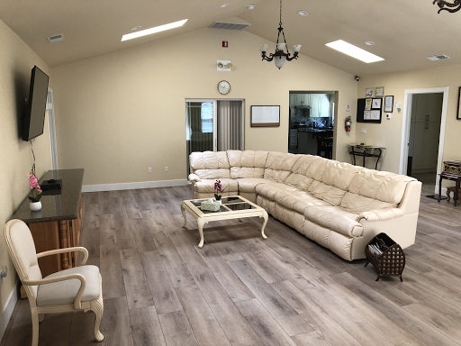 A spacious and modern living room featuring a large beige sectional couch and wooden flooring.