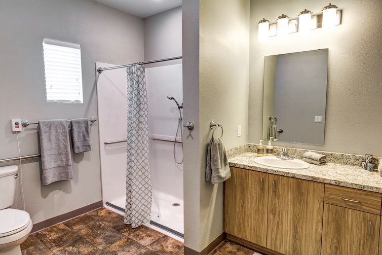 Modern bathroom with a walk-in shower and wooden vanity.