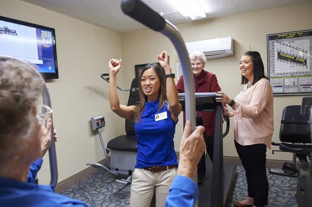 A group of people engaging in a fitness session at the gym with enthusiasm.