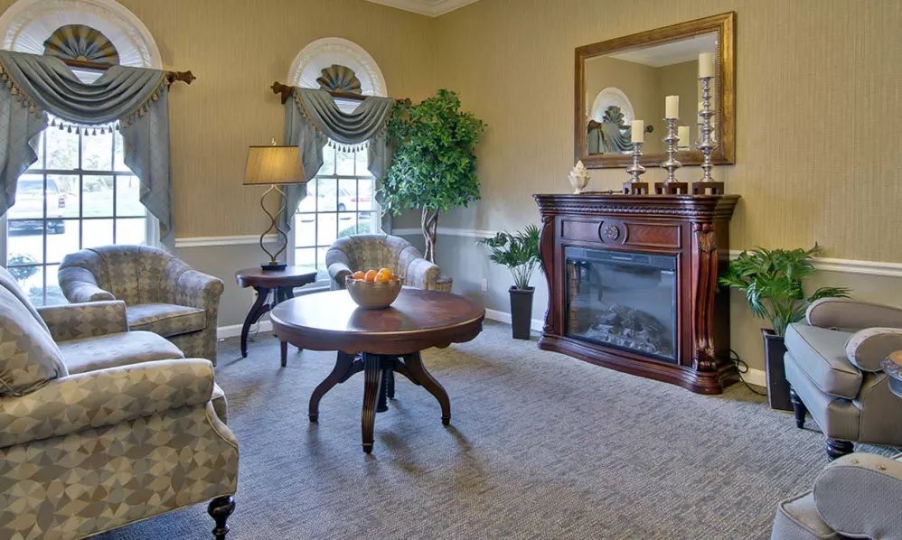 A traditional living room featuring a fireplace, elegant furniture, and stylish decor.