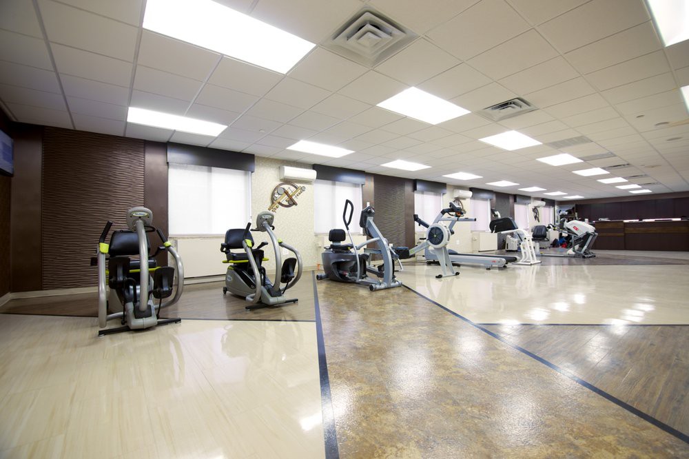 A spacious gym with various exercise machines and equipment.