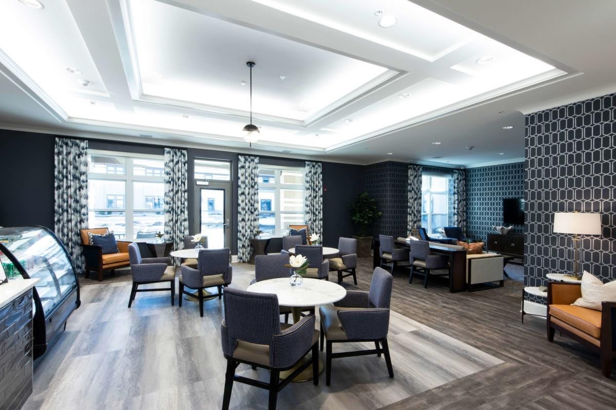 A modern lounge area with stylish furniture and soft lighting.