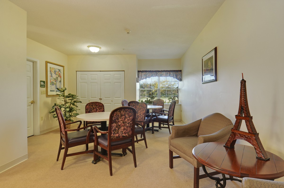 A cozy dining area with a table, multiple chairs, and decorative elements.