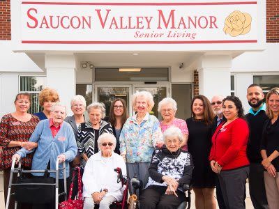 A group of seniors and caregivers standing outside Saucon Valley Manor.