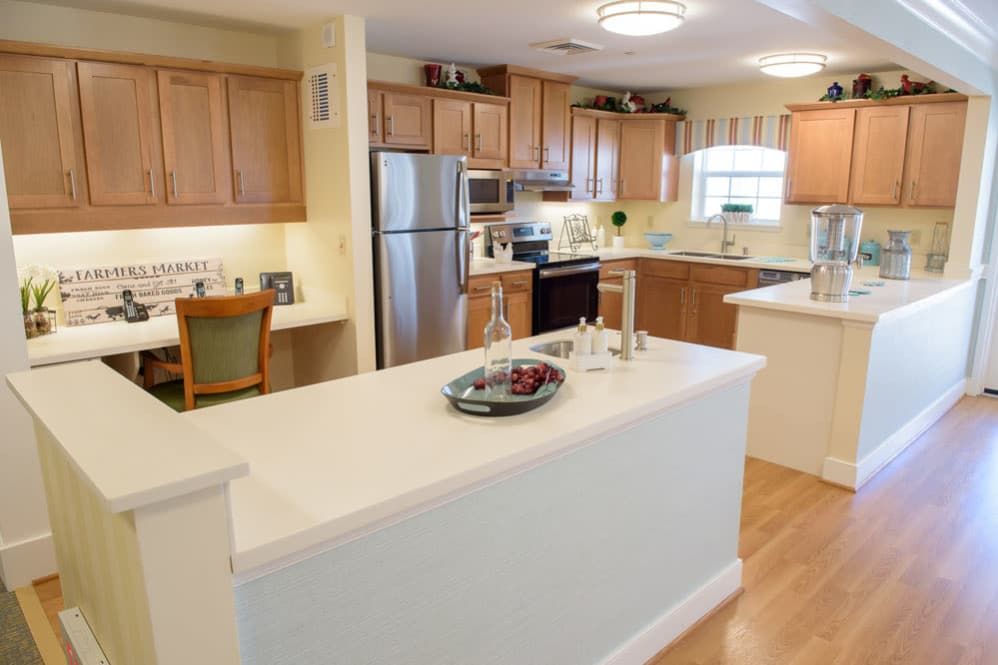 A modern kitchen with wooden cabinets and a central island.