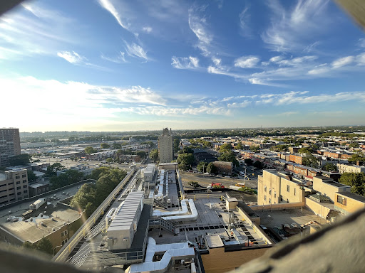A panoramic view of the city showcasing modern architecture under a clear blue sky.