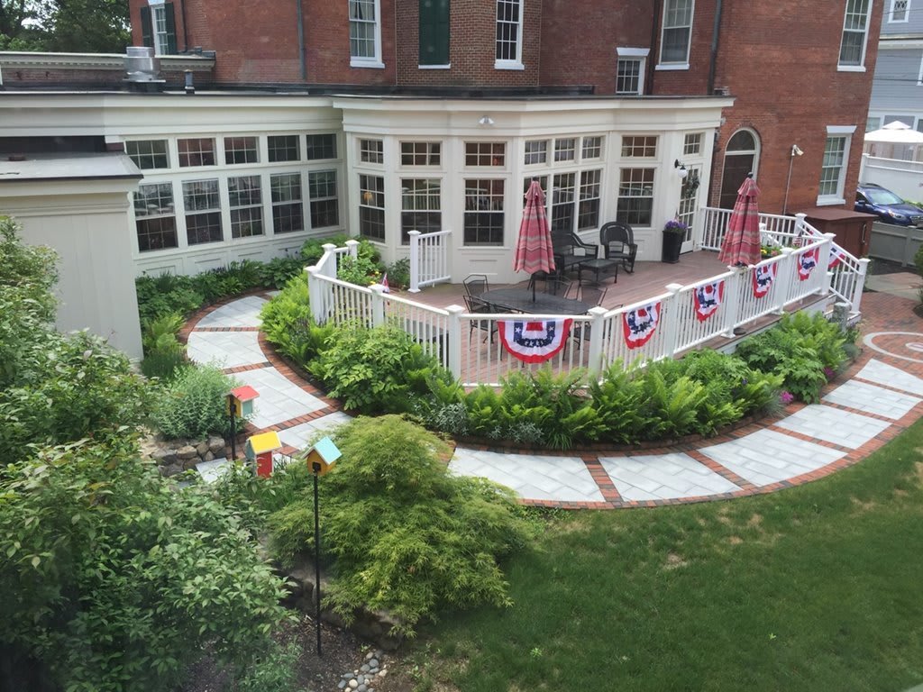 A beautifully landscaped patio area with festive decorations and lush greenery.