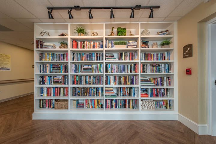 A neatly organized bookshelf filled with a diverse collection of books.