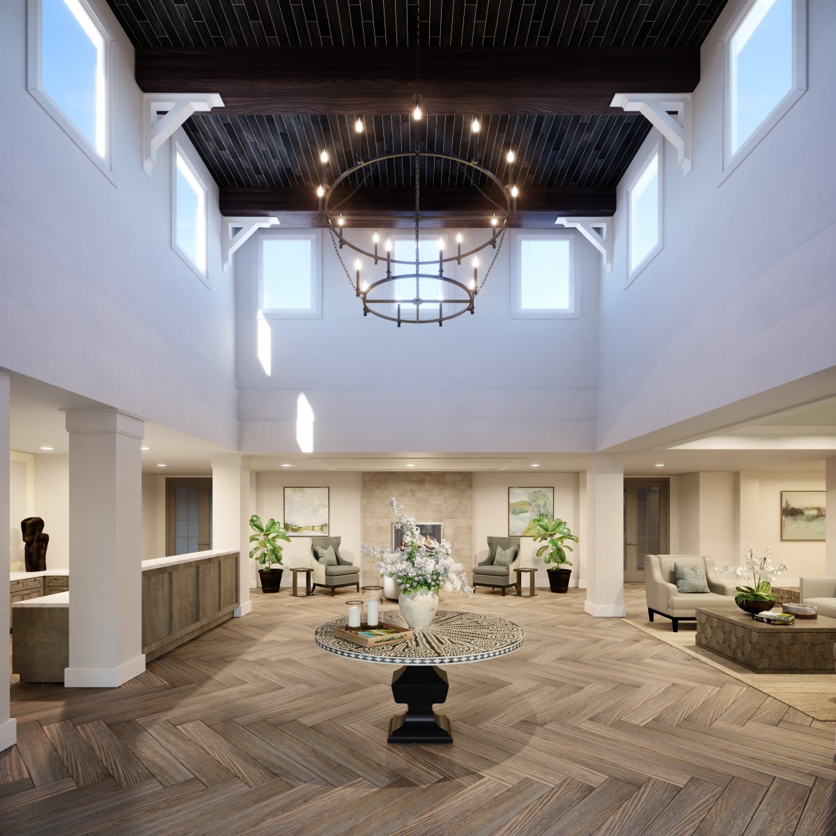 A modern and spacious lobby interior featuring a large chandelier, natural lighting, and elegant furnishings.