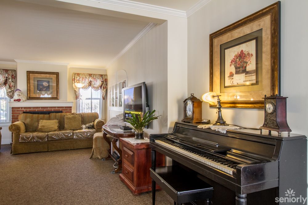 Cozy living room with a piano and traditional decor.