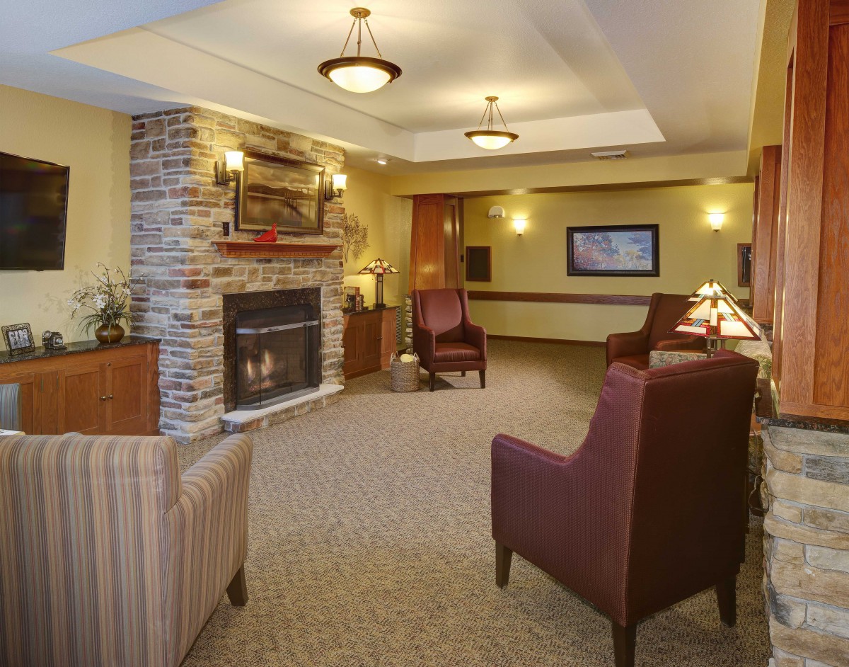 A cozy living room with a fireplace and comfortable seating.