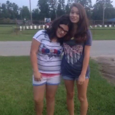 Two friends enjoying a summer day outdoors.