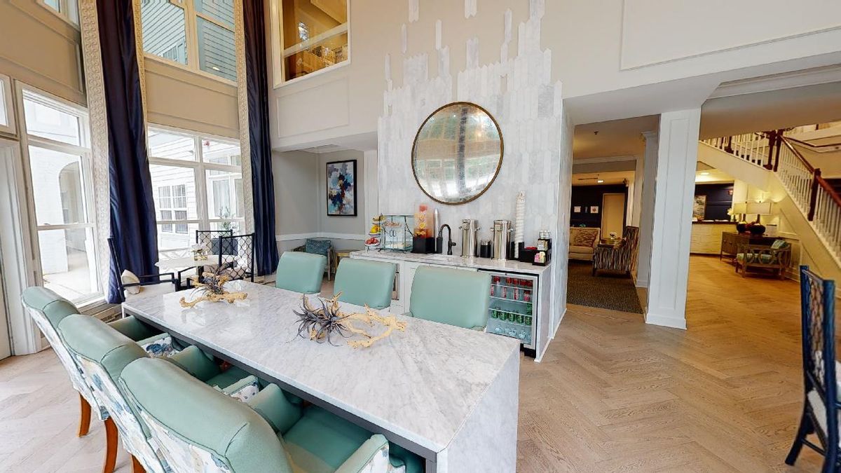 A modern dining room with elegant furniture and a stylish bar area.