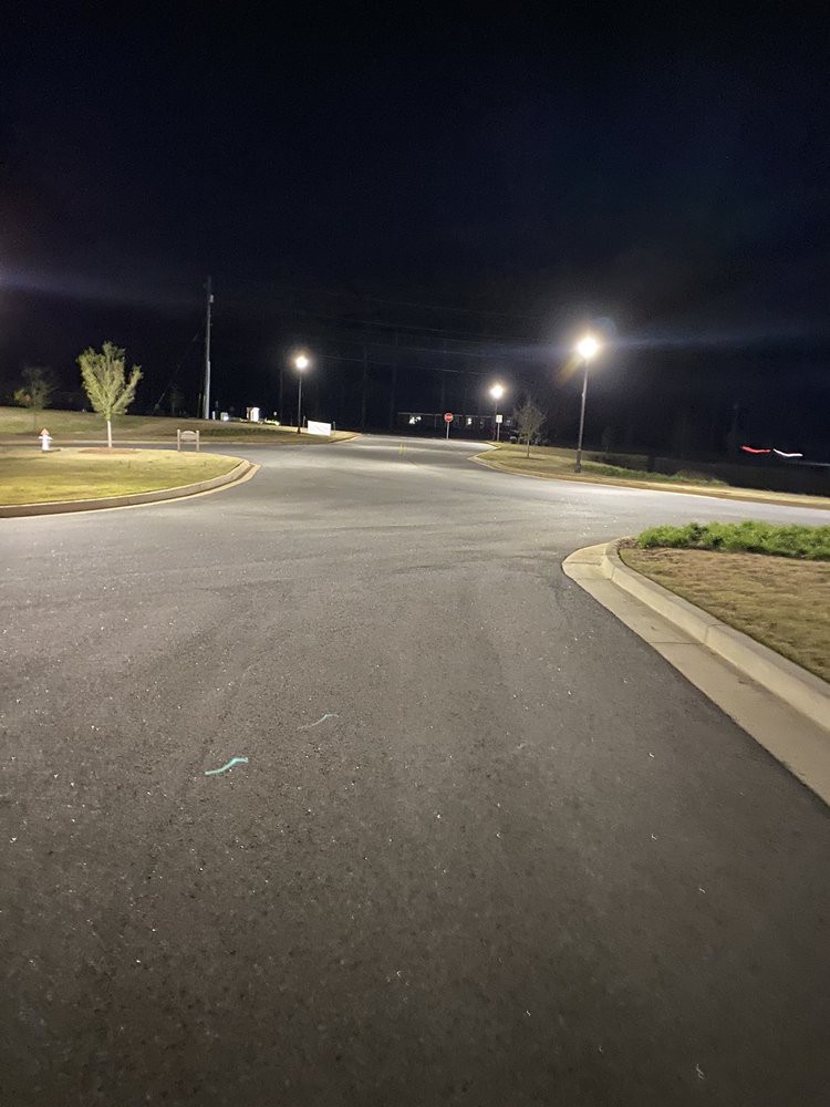 A dimly lit empty intersection at night.