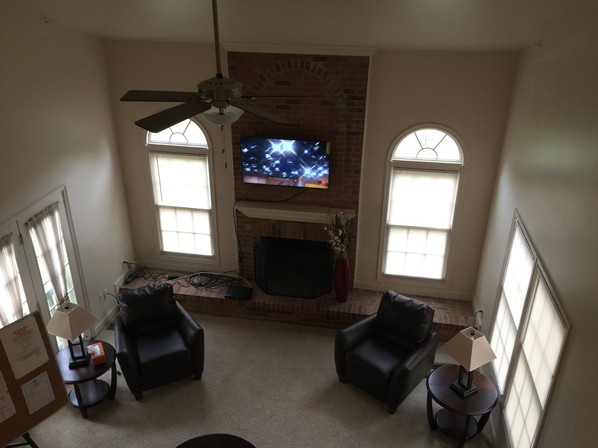 A cozy living room with a fireplace and TV, viewed from above.