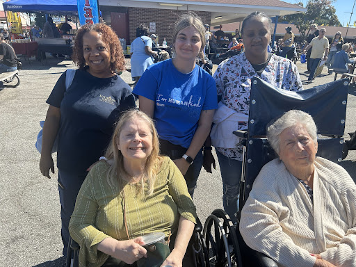 A joyful moment captured at a community event, featuring individuals of different ages enjoying their time together.