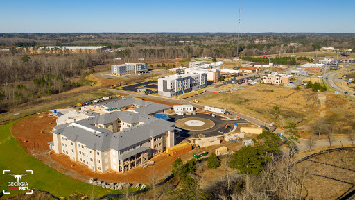 Aerial view of a developing urban area featuring various buildings and open land.