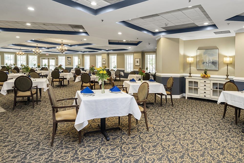 An elegant dining room with neatly arranged tables and chairs, featuring sophisticated decor.