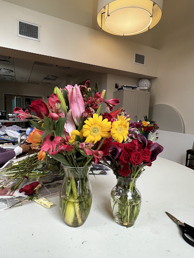 A vibrant display of mixed flower bouquets arranged in glass vases on a table.