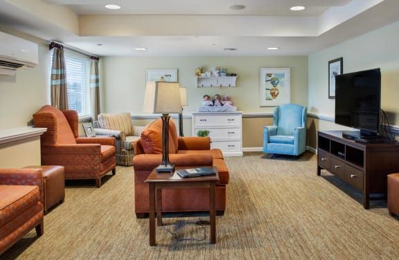 A cozy living room featuring comfortable armchairs, a lamp, and tastefully arranged decorations.