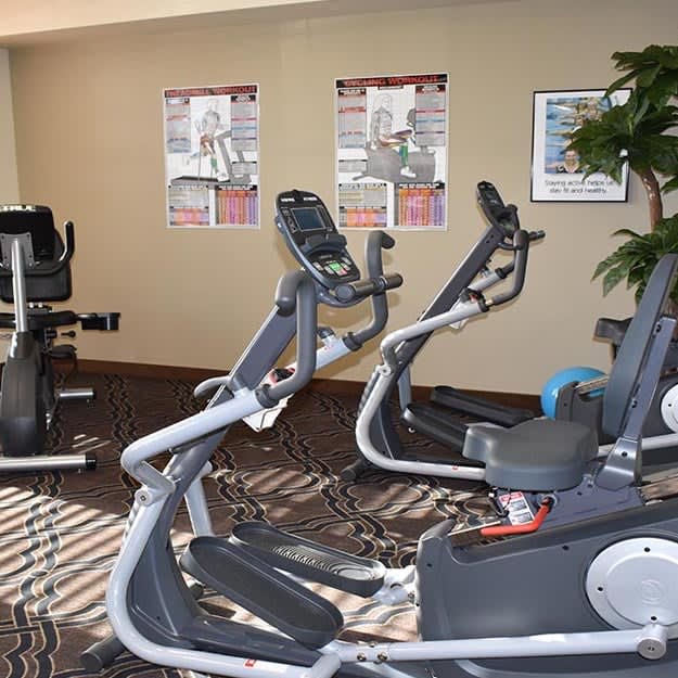 A fitness room with several stationary bikes and exercise equipment.