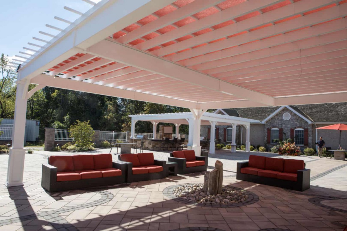 A stylish outdoor seating area with a pergola providing shade.