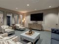 A modern living room with comfortable seating and a large television.