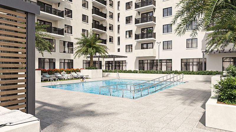 A modern residential complex with a swimming pool surrounded by palm trees.
