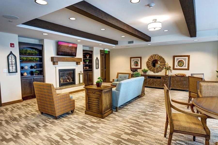 A modern living room with cozy seating, a fireplace, and stylish decor.