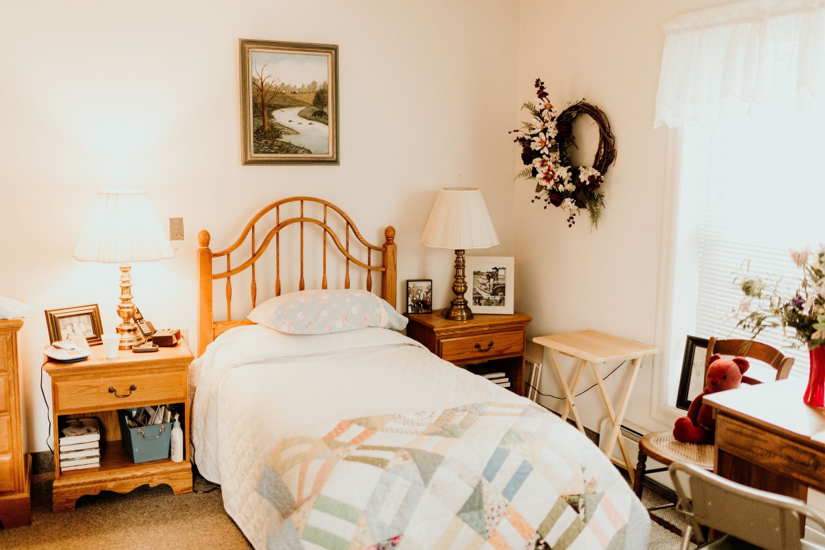 A cozy, well-decorated bedroom with a single bed and wooden furniture.