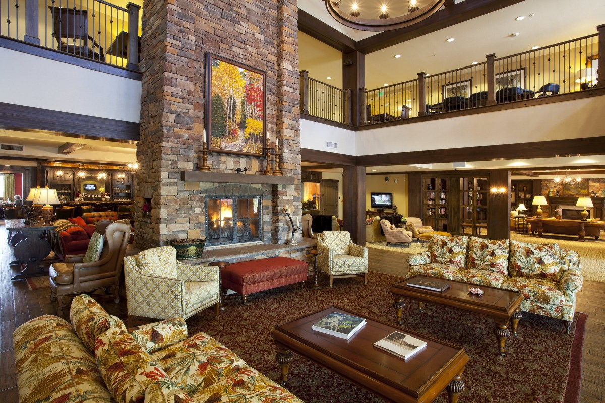Elegant hotel lobby with comfortable seating and a central fireplace.