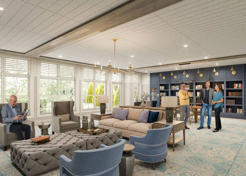 A modern living room with elegant furnishings, featuring large windows, comfortable seating, and stylish chandeliers.
