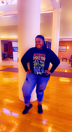 A cheerful individual showcasing a positive mindset in a cozy indoor setting.