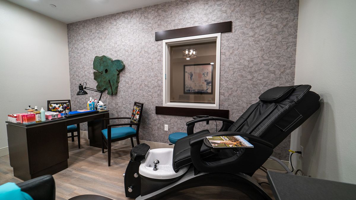 A relaxing spa room featuring a pedicure chair and stylish decor.